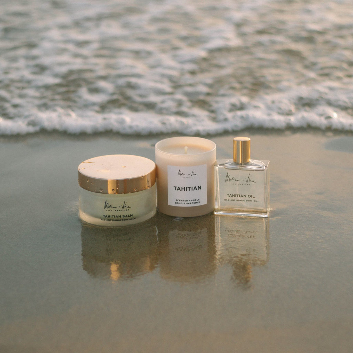 Marine + Vine gift card: Tahitian Balm, Tahitian Candle and Tahitian Oil on the shoreline